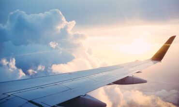 Airplane wing in the clouds